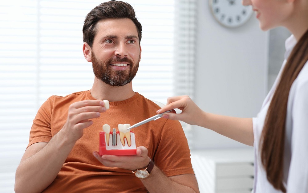 Dentist discussing dental implants with male patient
