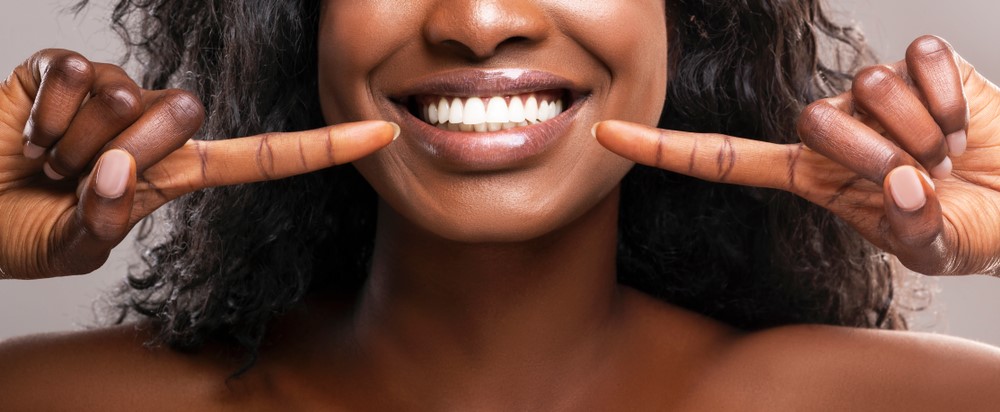 A woman smiling with straight white teeth